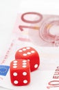 Two red dices on ten euro bill Royalty Free Stock Photo