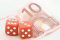 Two red dices on ten euro bill Royalty Free Stock Photo