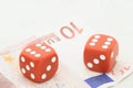 Two red dices on ten euro bill Royalty Free Stock Photo