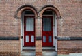 Two red doors in a brick wall Royalty Free Stock Photo