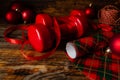 Gym dumbbells as a Christmas gift idea. Composition with wrapping paper, string and ornaments. Royalty Free Stock Photo