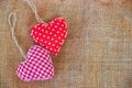 Two red fabric hearts on rustic canvas Royalty Free Stock Photo