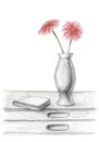 Two red flowers in a vase on desk with book