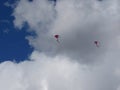 Two red flying kites on a cloudy sky Royalty Free Stock Photo