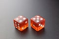 Two red glass dice on a black matte background with side lighting. Four and five with copy space. Royalty Free Stock Photo