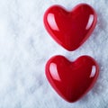 Two red glossy hearts on a frosty white snow background. Love and St. Valentine concept