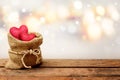 Two red heart in burlap sack on wooden table with bokeh background Royalty Free Stock Photo