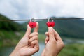 Two red heart keys There is a hand held on a steel rope. Nature background, concept of love, symbolizes the feeling of Valentine` Royalty Free Stock Photo