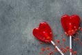 Two Red Heart Shape Candy Lollipops on Sticks Flowers on Dark Stone Background. Valentine Romantic Love Greeting Card Royalty Free Stock Photo