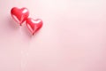 Two red heart-shaped balloons on a string.Valentine\'s Day banner with space for your own content. White background color. Royalty Free Stock Photo