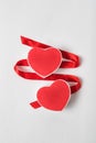 Two red heart-shaped boxes and satin ribbon on a white background. Symbol of love, Valentine`s Day Royalty Free Stock Photo