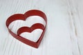Two Red Heart Shaped cookie Cutter on wooden White back Royalty Free Stock Photo