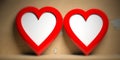 Two red heart shaped empty frames on yellow wall background, copy space Royalty Free Stock Photo