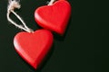 Two Red Heart-Shaped Wood Chains on Black Background