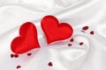 Two red heart on white silk