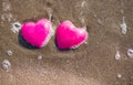 Two red hearts on the beach symbolizing love Royalty Free Stock Photo