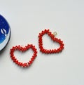 Two red hearts from beads valentine& x27;s on a white background Royalty Free Stock Photo