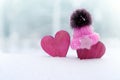 Two red hearts in cap on snow background. couple in love. Valentine`s Day. Red heart on snowy tree branch in winter. Holidays Royalty Free Stock Photo