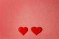 Two red hearts on a red color cardboard background. Copy space, Valentines Day concept Royalty Free Stock Photo