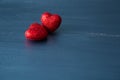 Two red hearts on dark blue or silver on wooden or metal background. Valentine`s Day Royalty Free Stock Photo
