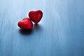 Two red hearts on dark blue or silver on wooden or metal background. Valentine's Day Royalty Free Stock Photo