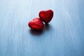 Two red hearts on dark blue or silver on wooden or metal background. Valentine`s Day Royalty Free Stock Photo