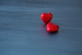 Two red hearts on dark blue or silver on wooden or metal background. Valentine`s Day Royalty Free Stock Photo