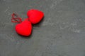 Two red hearts on a dark gray concrete background. Concept of romantic relationship and Valentine`s Day celebration Royalty Free Stock Photo