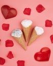 Two red hearts, ice creams and rose petals on pink background Royalty Free Stock Photo