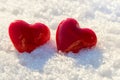 Two red hearts on ice wet snow, selective focus Royalty Free Stock Photo