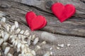 Two red hearts on natural wooden and burlap background. Valentine day greeting card. Eco concept Royalty Free Stock Photo