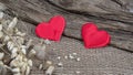 Two red hearts on natural wooden and burlap background. Valentine day greeting card. Eco friendly Royalty Free Stock Photo