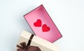 Two red hearts in an open gift box on a light background. Royalty Free Stock Photo