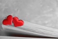 Two red hearts on pages of book, monochrome retro effect , love in valentine`s day concept