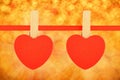Two red hearts at ribbon over golden glitter blur Royalty Free Stock Photo