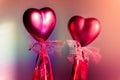 Two red hearts with ribbons on a creative neon colorful background, Valentines day decoration Royalty Free Stock Photo