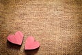 Two red hearts on sackcloth, canvas background. Vintage style. Royalty Free Stock Photo