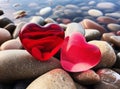 Two red hearts on sea rocks Royalty Free Stock Photo