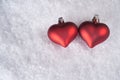 Two red hearts on snow Royalty Free Stock Photo