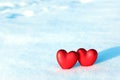 Two Red Hearts in the Snow. Royalty Free Stock Photo