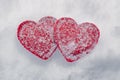 Two red hearts in the snow, love concept and valentine`s day background Royalty Free Stock Photo