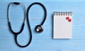 Two Red hearts with stethoscope, blank notepad. Royalty Free Stock Photo