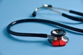 Two Red hearts with stethoscope on blue background. Royalty Free Stock Photo