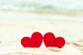 Two red hearts on the summer beach. Royalty Free Stock Photo