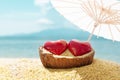 Two red hearts under beach umbrella, blue sky and sea in background. Valentines Day, 14 February symbol. Copy space Royalty Free Stock Photo