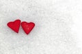 Two red hearts.Two red hearts on white snowy textured bokeh background