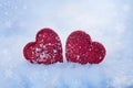 Two red hearts on winter snow, Valentine`s Day background, photo with texture Royalty Free Stock Photo