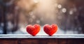 Two red hearts on wooden bench in snowy urban park in winter time Royalty Free Stock Photo