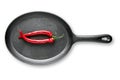 Two red hot hot peppers lie in the form of lips on a black cast iron frying pan isolated on a white background. Hot Royalty Free Stock Photo