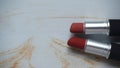 two red lipsticks on a white wooden table Royalty Free Stock Photo